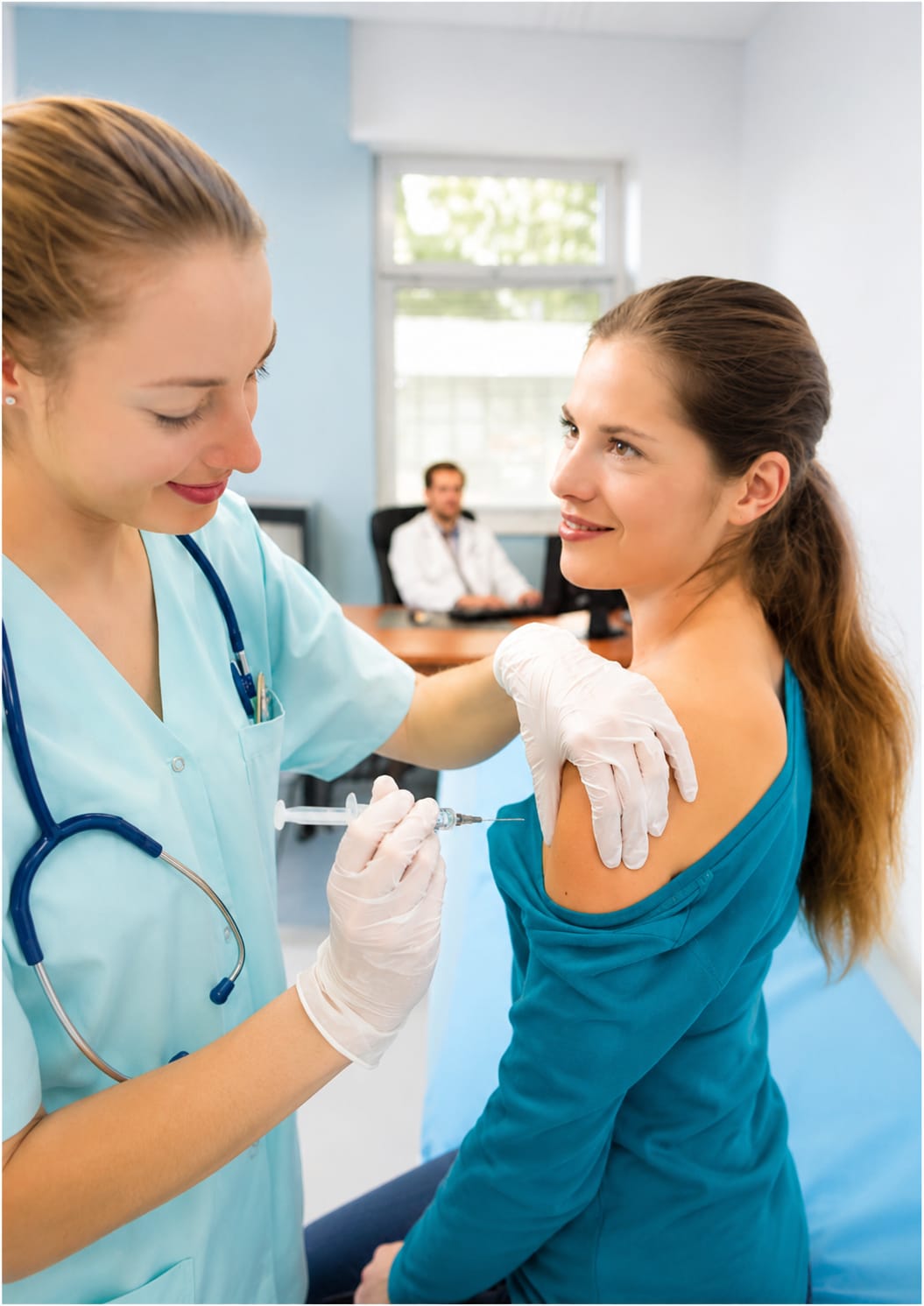 Nurse administering an injection to a patient