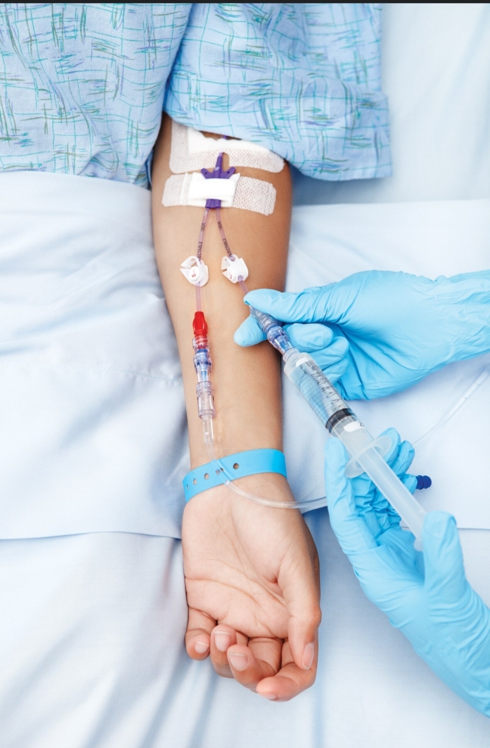 Nurse administering medication through an IV line