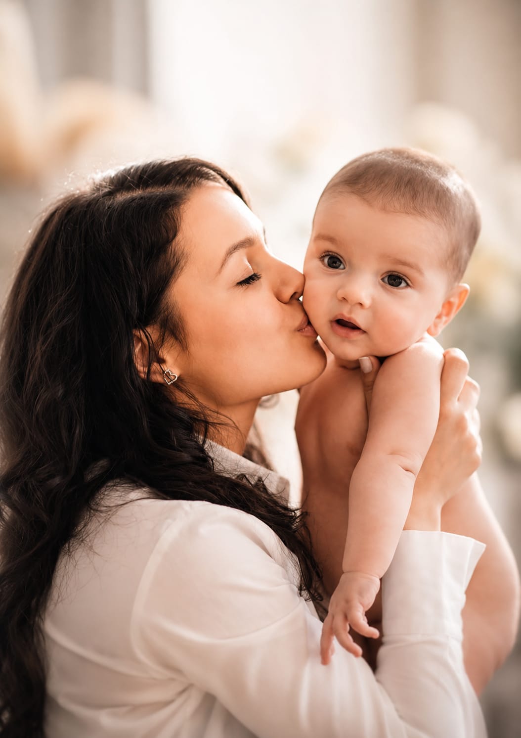 Mother holding her newborn baby at home