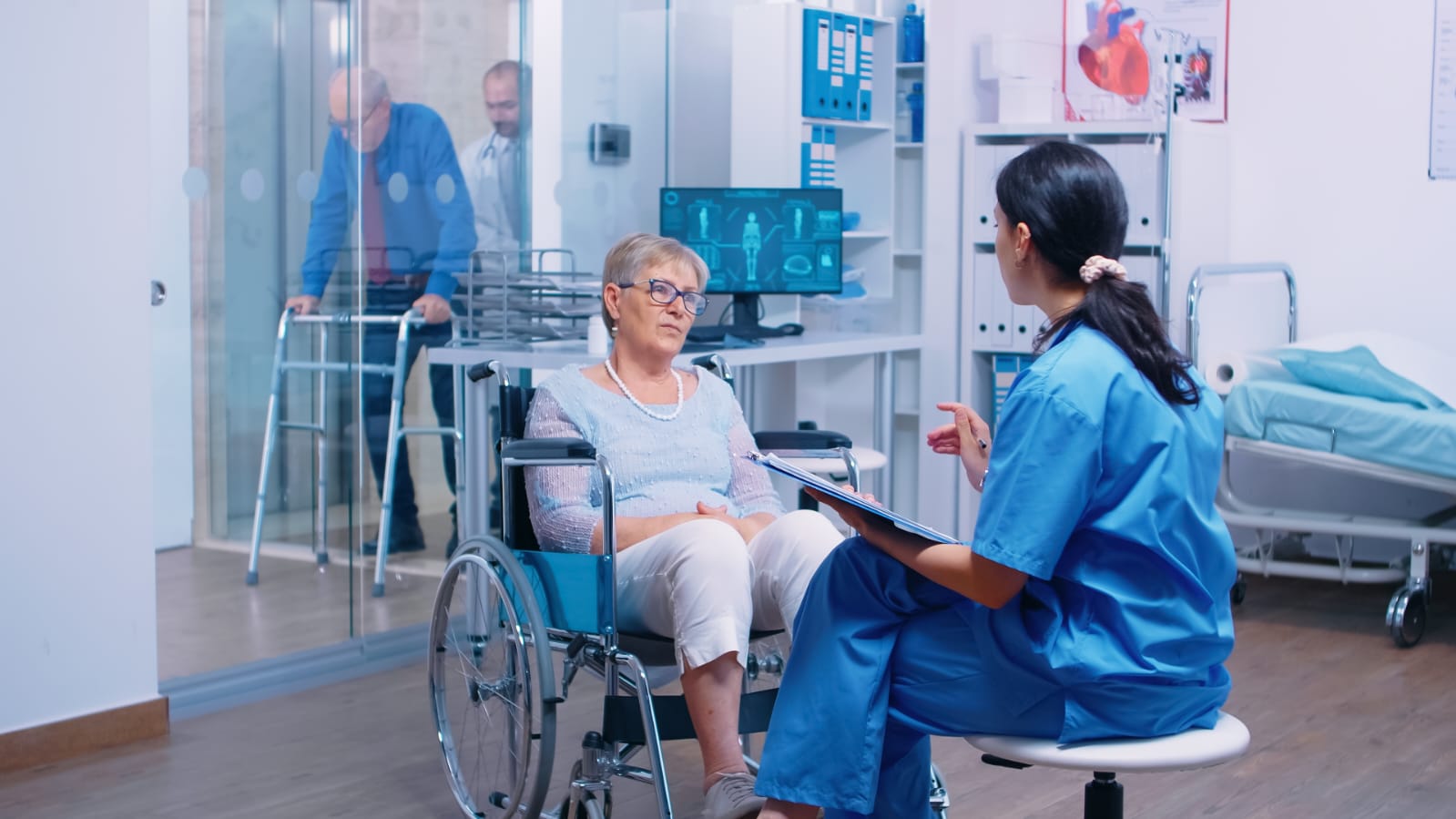 Nurse assisting an elderly patient in a wheelchair